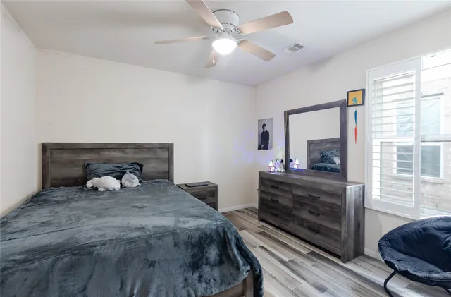 an empty room with a window and a fan