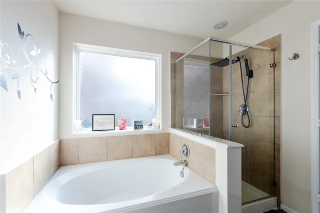 a spacious bedroom with a bed a couch and a window