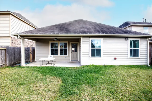 a view of a house with a backyard