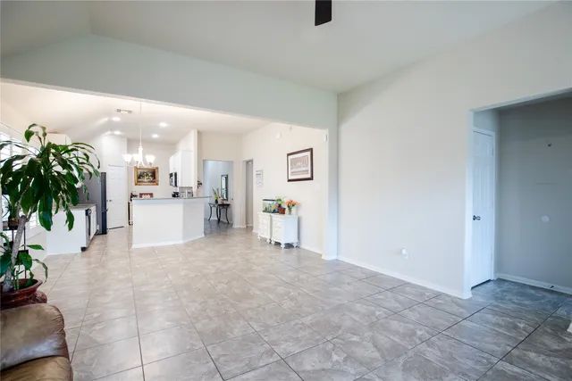 a living room with furniture and kitchen view