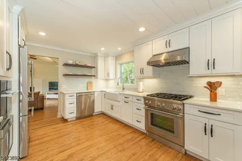a kitchen with a stove top oven sink and cabinets