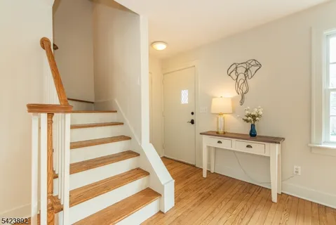 a view of a room with a sink and wooden floor