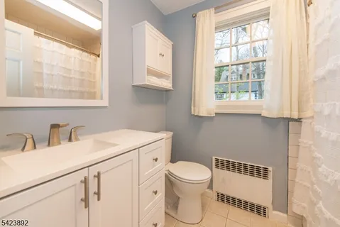 a bathroom with a toilet sink and window