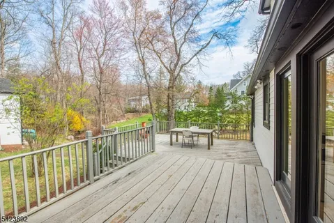 a view of a two chairs with wooden floor and fence