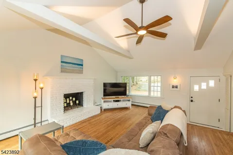 a living room with furniture fireplace and a flat screen tv