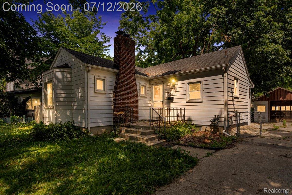 624 North Prospect Road Ypsilanti, MI 48198 - Photo 1 of 28 White siding exterior with a prominent brick chimney
