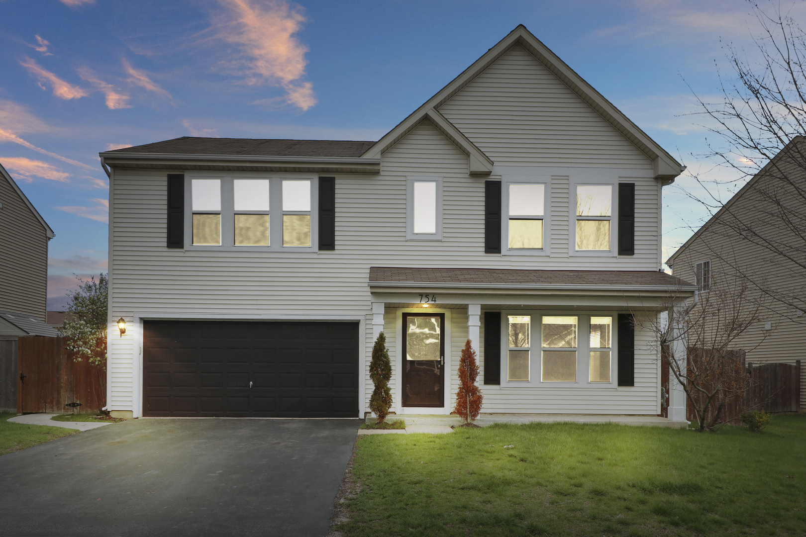 a front view of a house with a yard and porch