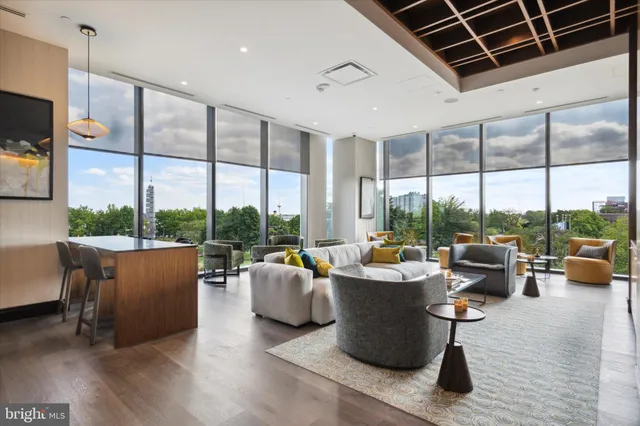 a living room with patio furniture and a potted plant