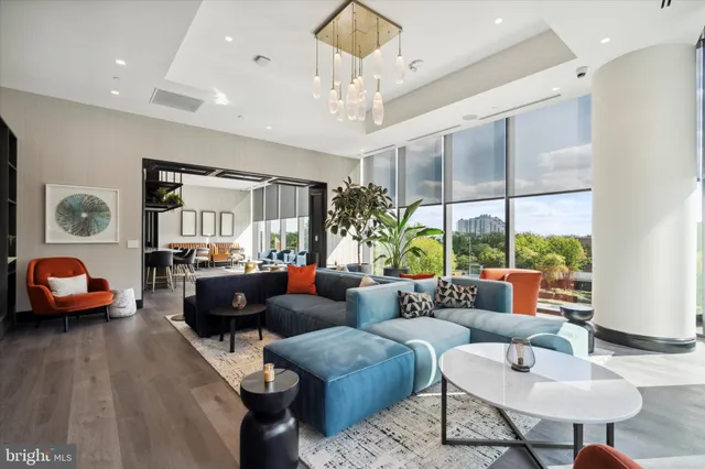 a living room with furniture a table and a large window