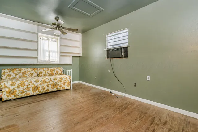 a bedroom with a bed couch and window