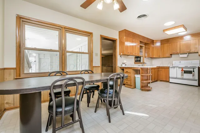 a view of a dining room with furniture and a window