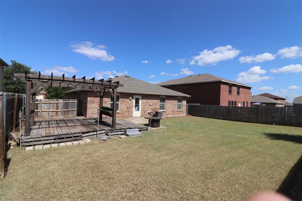 8416 River Bluffs Drive Arlington, TX 76002 - Photo 3 of 4 a view of a house with floor to ceiling windows and a large tree