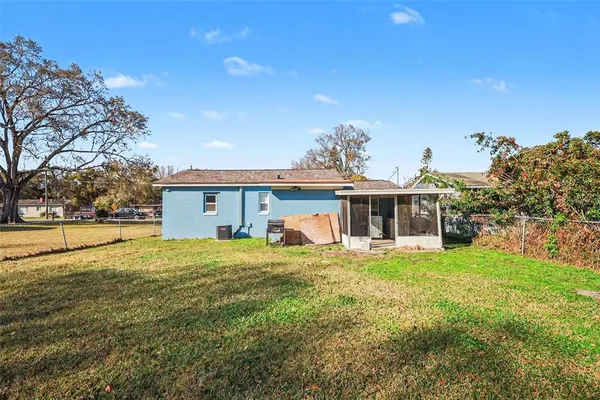 a view of a house with backyard and sitting area