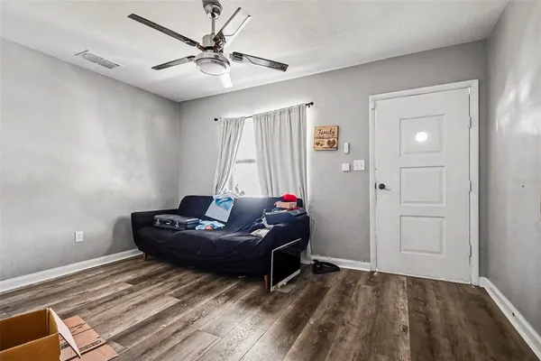 a living room with a bed furniture and a window