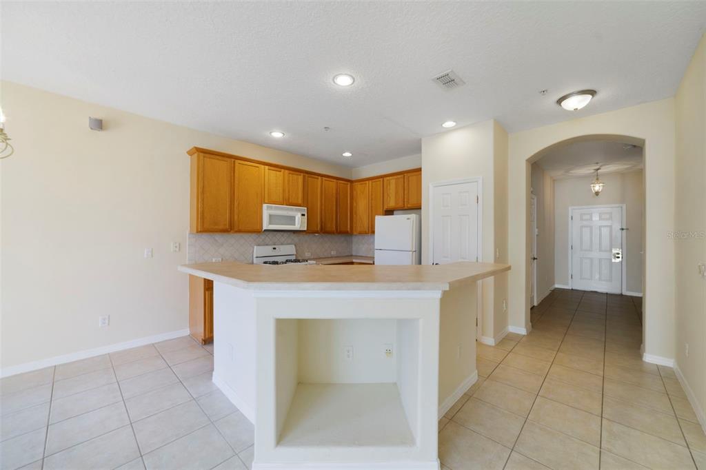 851 Assembly Court Kissimmee, FL 34747 - Photo 13 of 27 a open kitchen with kitchen island a sink stainless steel appliances and cabinets