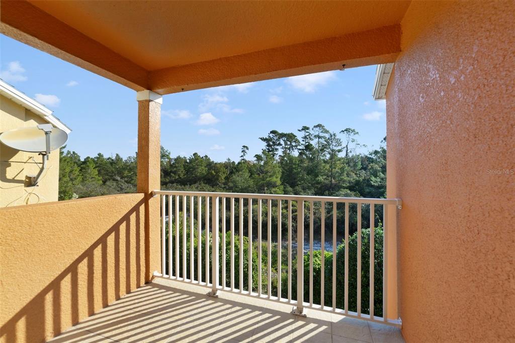 851 Assembly Court Kissimmee, FL 34747 - Photo 19 of 27 a view of a balcony with wooden floor