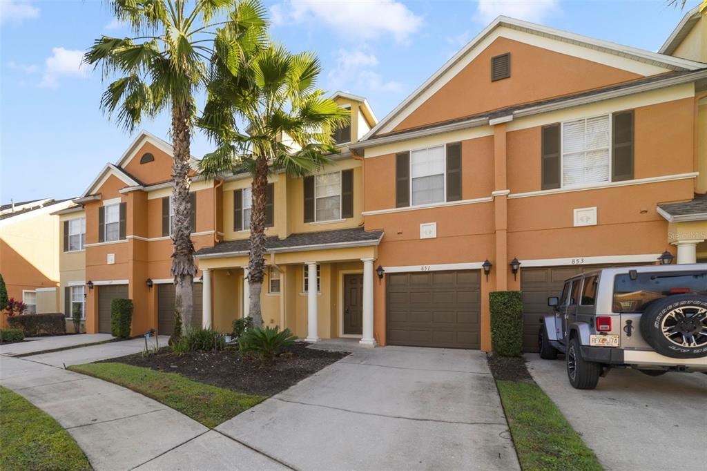 851 Assembly Court Kissimmee, FL 34747 - Photo 2 of 27 a front view of a house with a yard and garage