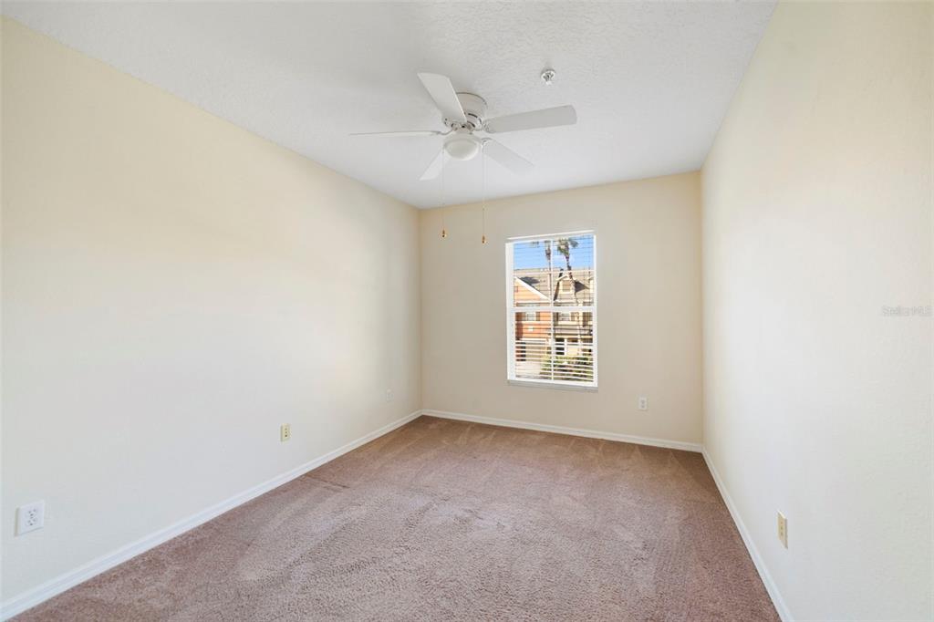 851 Assembly Court Kissimmee, FL 34747 - Photo 23 of 27 an empty room with a window and a fan