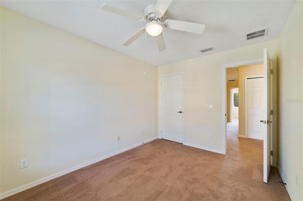 851 Assembly Court Kissimmee, FL 34747 - Photo 26 of 27 an empty room with a ceiling fan and a fan