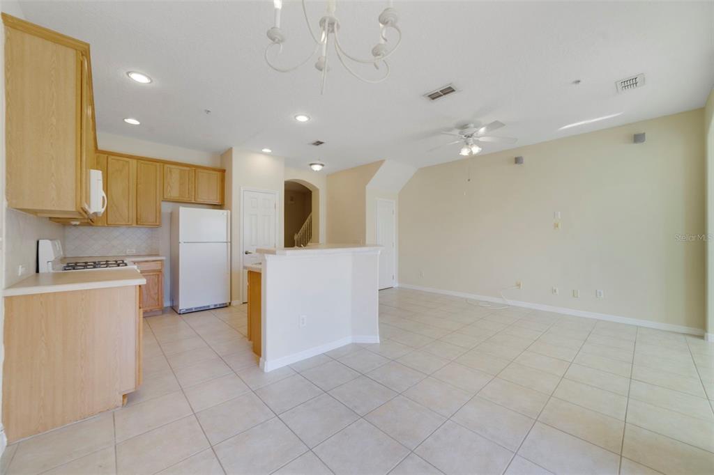 851 Assembly Court Kissimmee, FL 34747 - Photo 10 of 27 a view of a kitchen with a sink and dishwasher a refrigerator with white cabinets