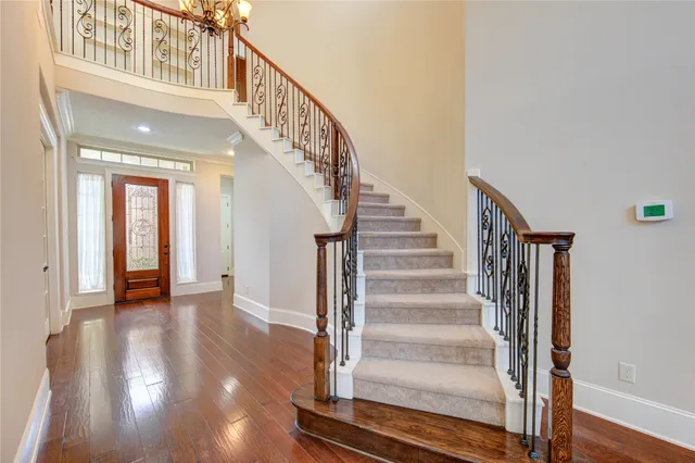 a view of staircase with wooden floor and a window