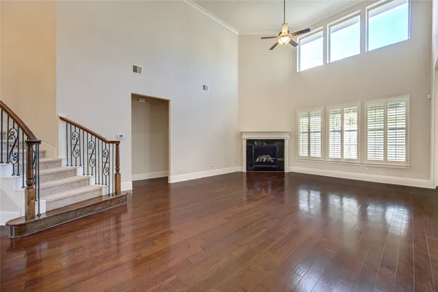a view of empty room with wooden floor and fireplace