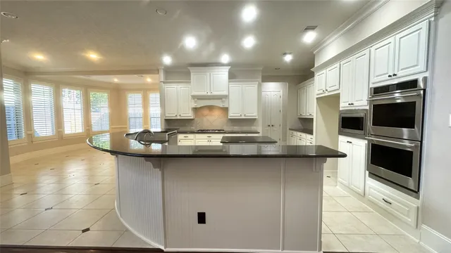 a kitchen with stainless steel appliances a sink stove and cabinets
