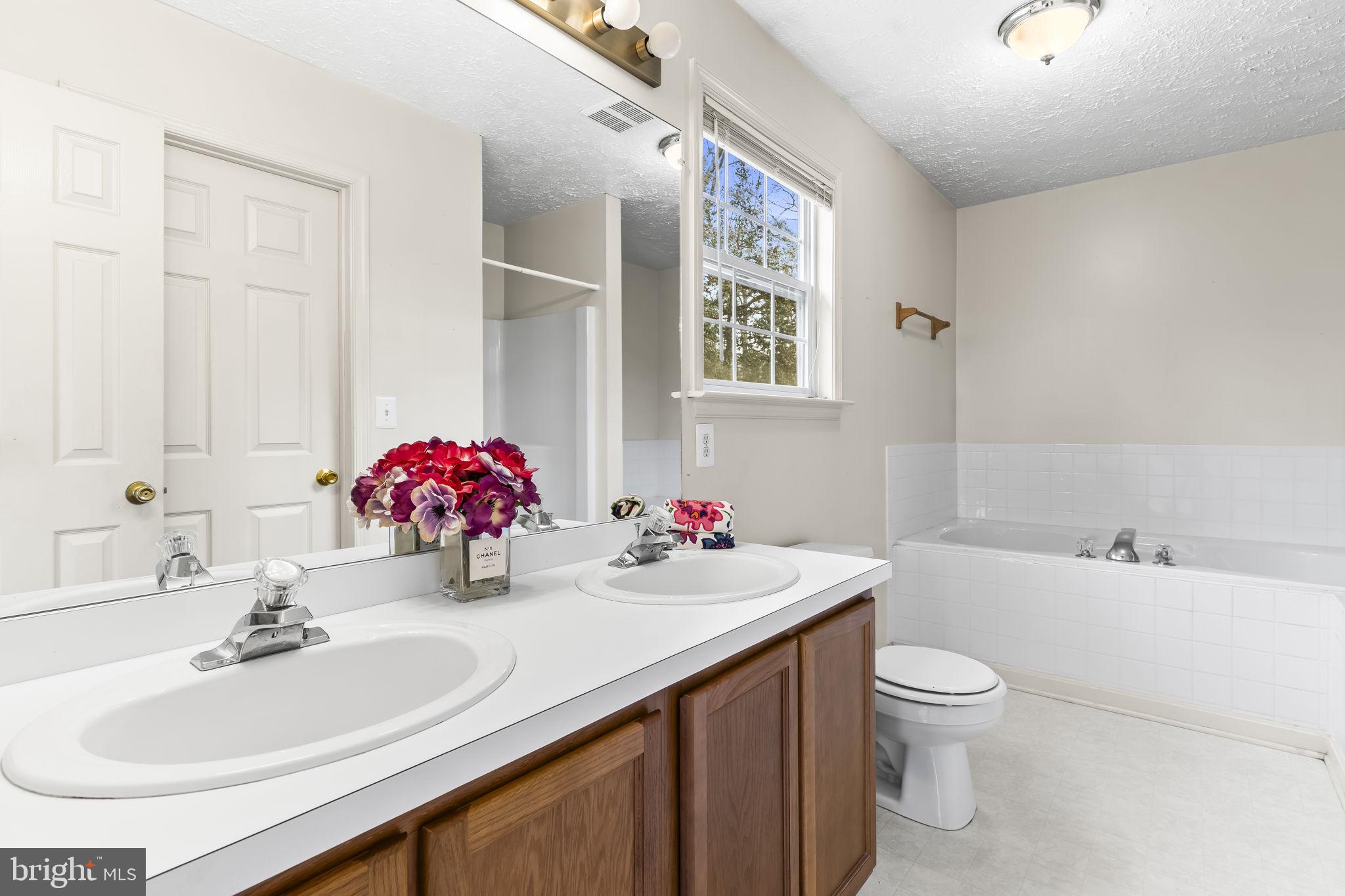 9400 Penns Hill Road La Plata, MD 20646 - Photo 23 of 39 a bathroom with a sink vanity mirror and toilet