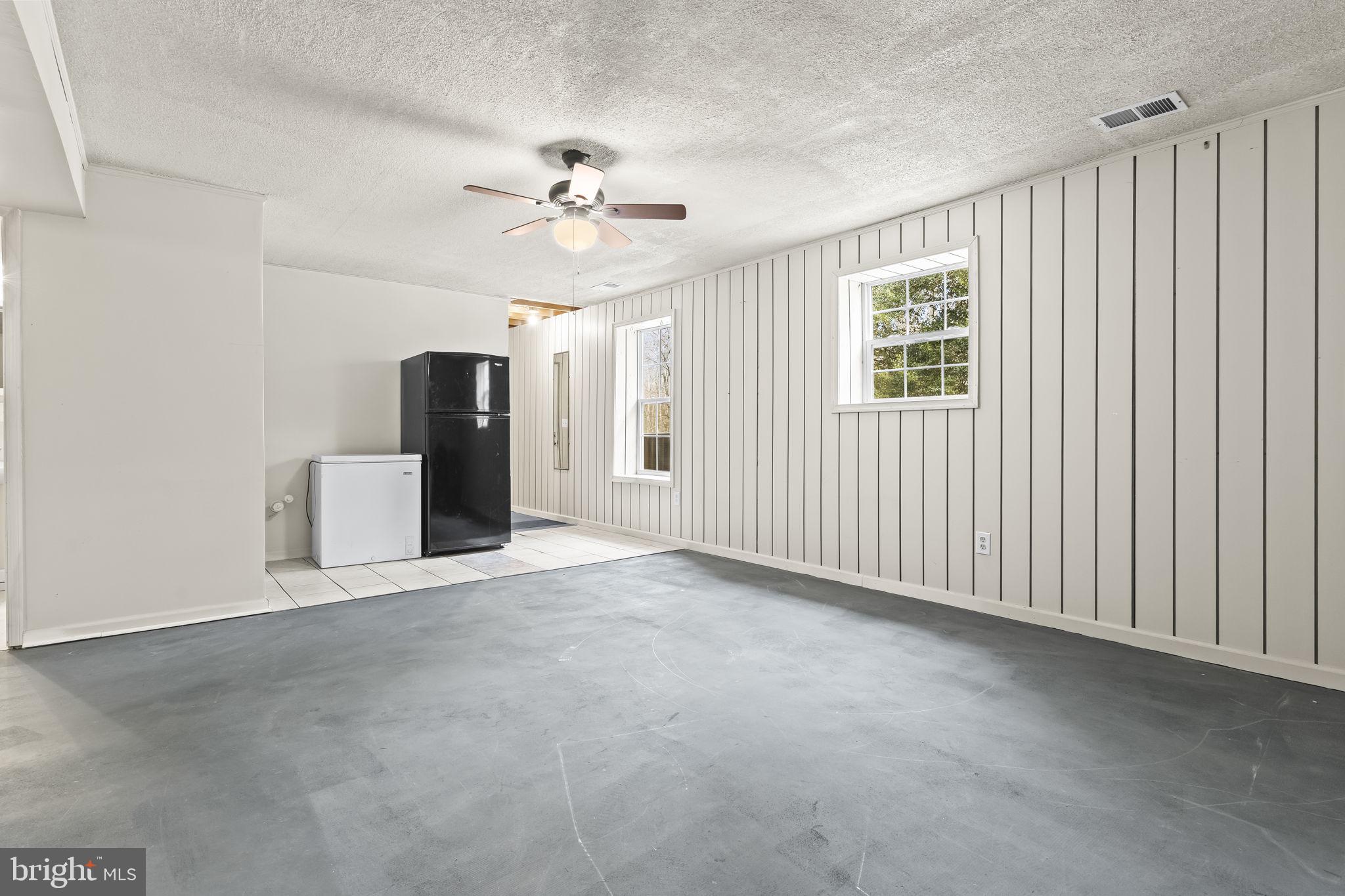9400 Penns Hill Road La Plata, MD 20646 - Photo 27 of 39 an empty room with chandelier fan and windows