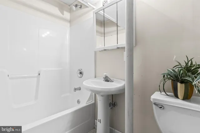 a living room with furniture a flat screen tv and a table