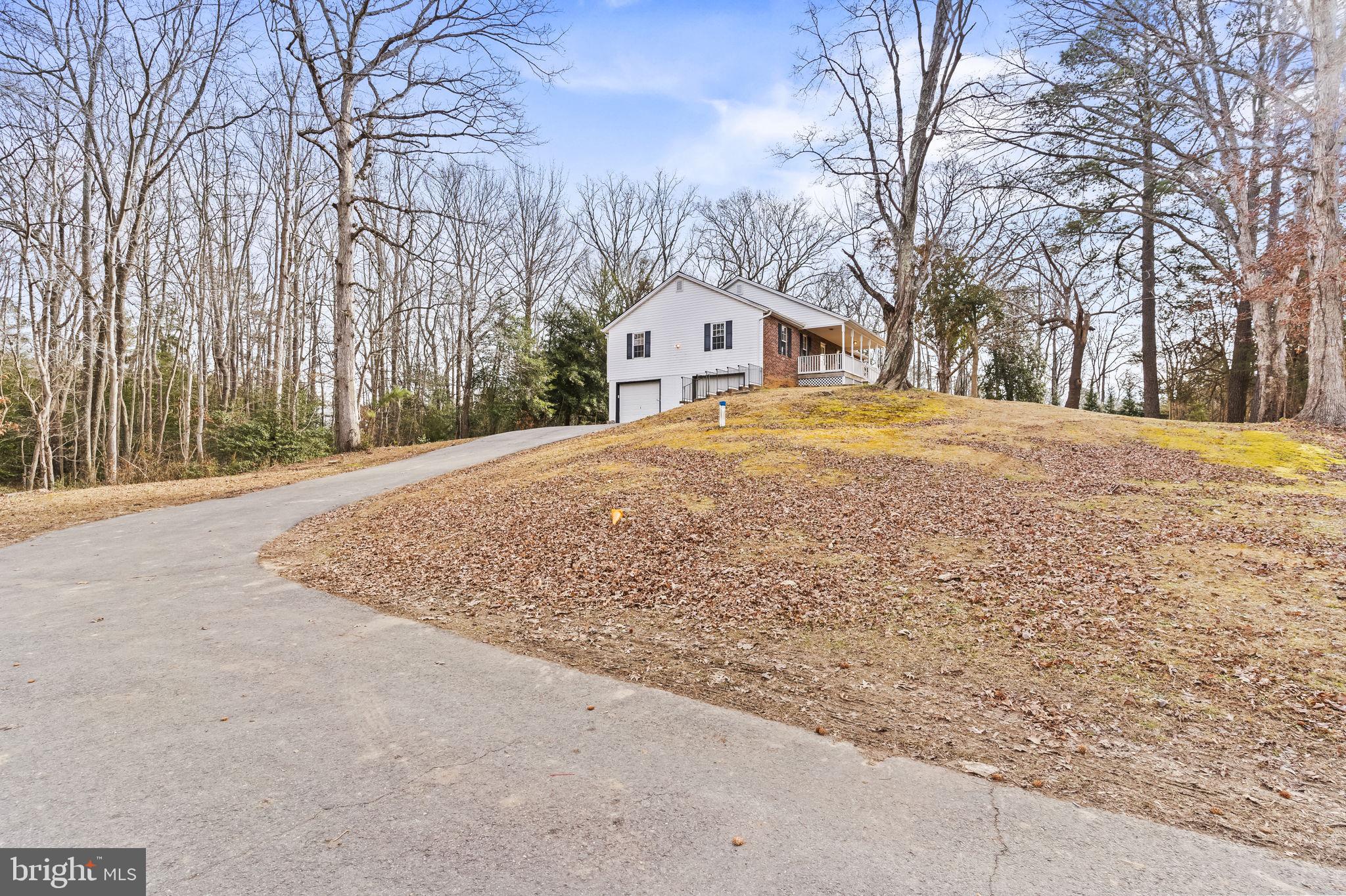 9400 Penns Hill Road La Plata, MD 20646 - Photo 3 of 39 a front view of a house with a yard covered with snow