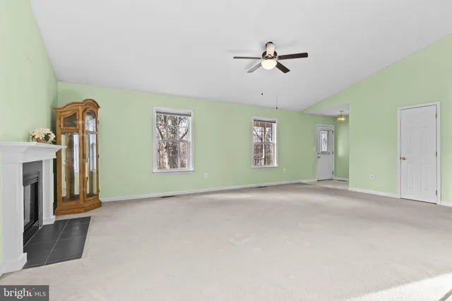 a view of a livingroom with a ceiling fan and window