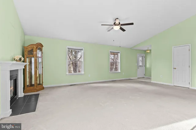 a view of a livingroom with a ceiling fan and window