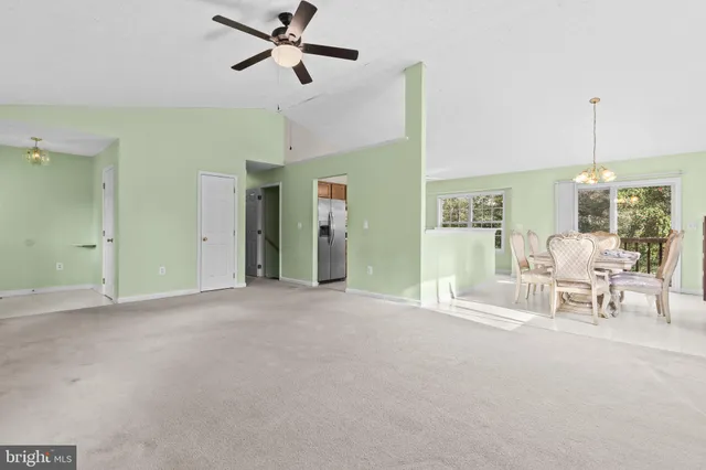 a view of a livingroom with a furniture a ceiling fan and a rug