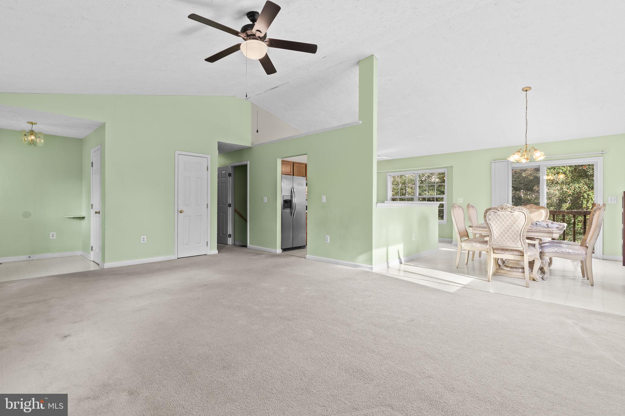 9400 Penns Hill Road La Plata, MD 20646 - Photo 9 of 39 a view of a livingroom with a furniture a ceiling fan and a rug