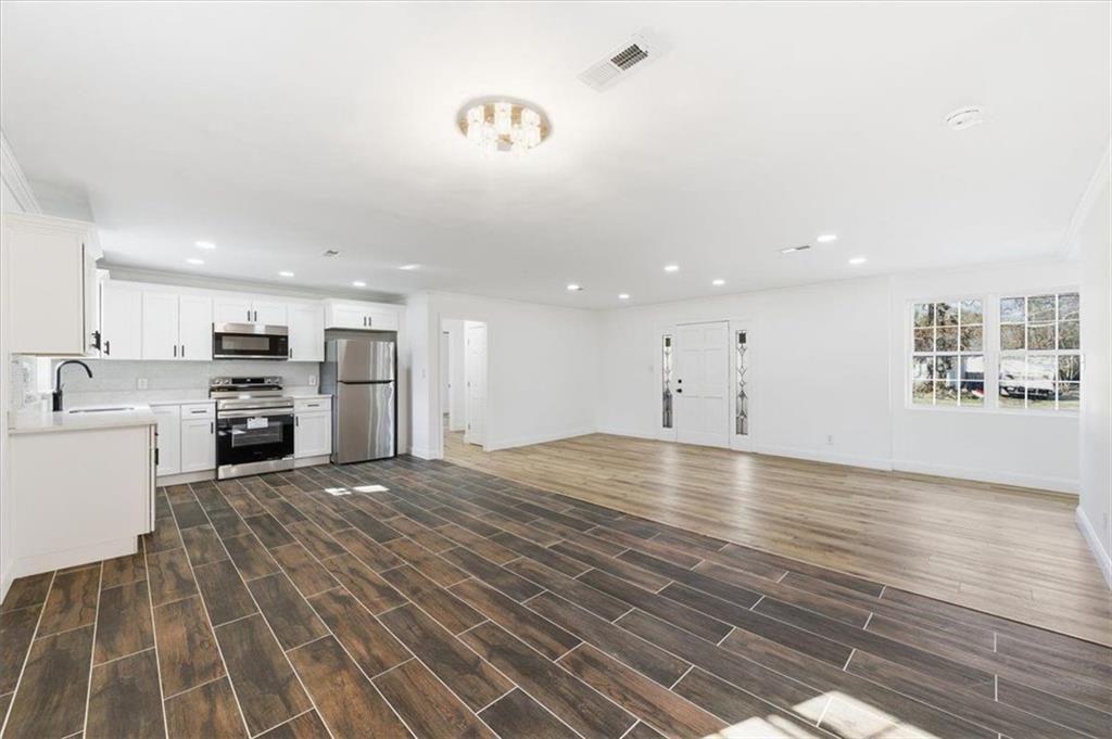 130 Malone Drive Rome, GA 30165 - Photo 11 of 45 a view of kitchen with wooden floor and electronic appliances