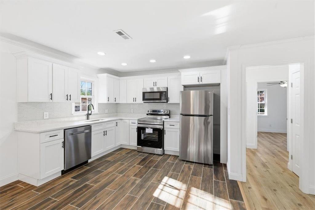 130 Malone Drive Rome, GA 30165 - Photo 7 of 45 a kitchen with a sink stainless steel appliances and cabinets