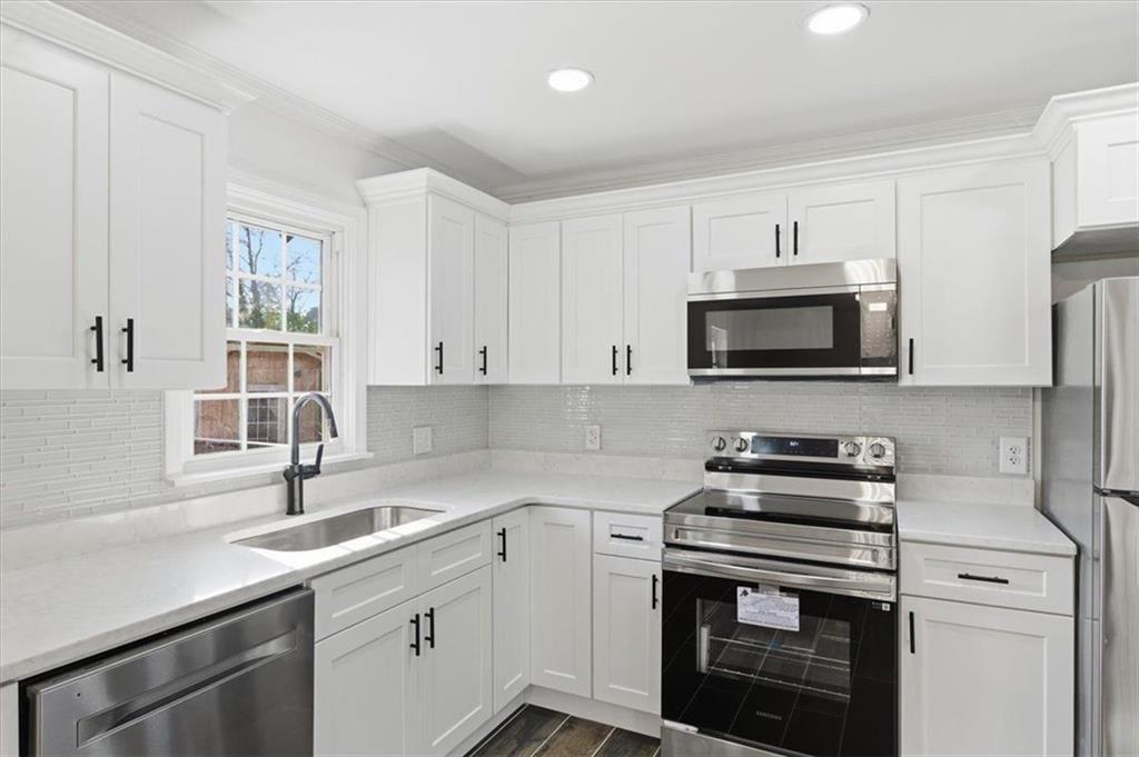 130 Malone Drive Rome, GA 30165 - Photo 8 of 45 a kitchen with stainless steel appliances white cabinets and a sink