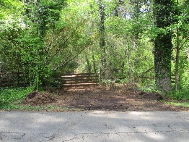 0 Honeycomb Road Grant, AL 35747 - Photo 2 of 8 a backyard of a house with trees and outdoor seating