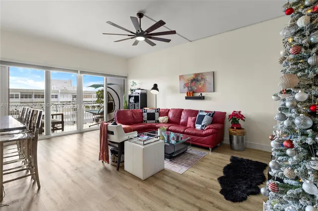 a living room with furniture and flowers