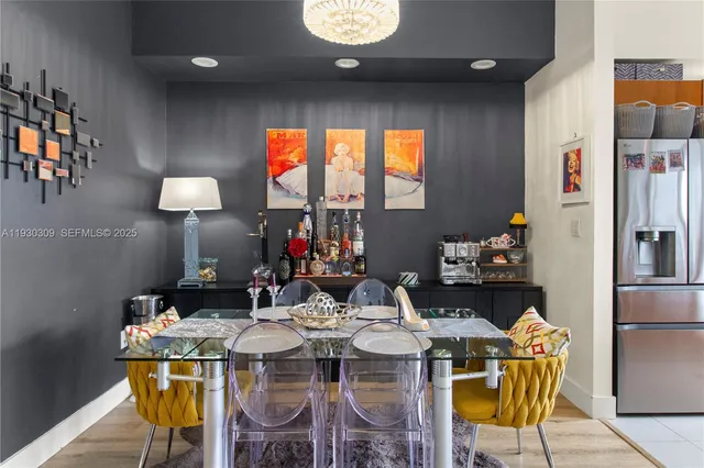 a view of a dining room with furniture and chandelier