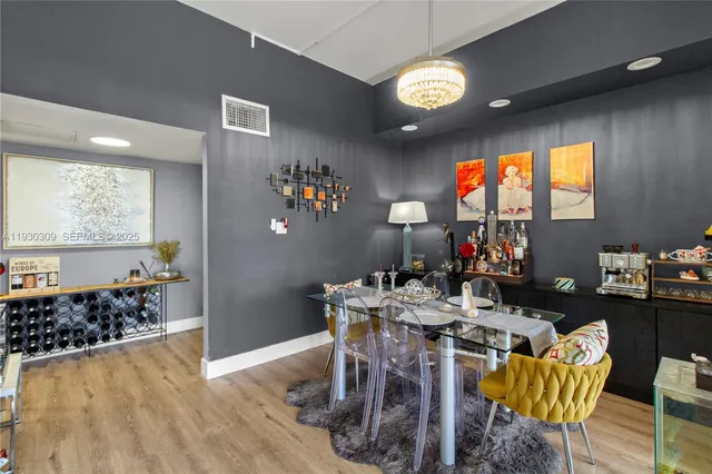 a view of a dining room with furniture and a large window