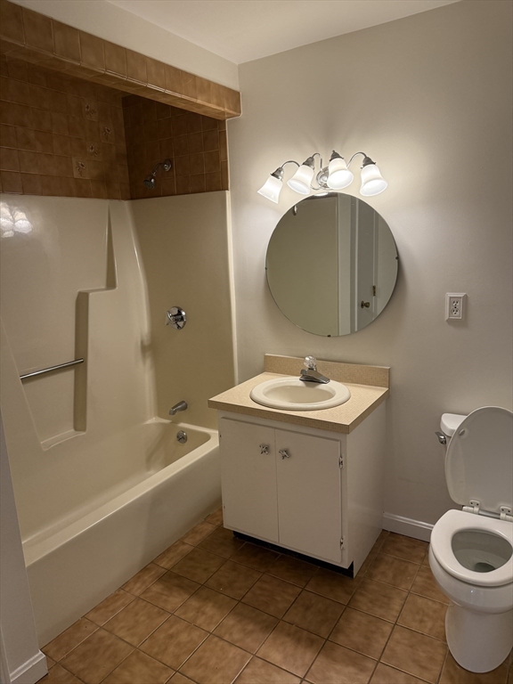 577 Adams Street, Unit D Milton, MA 02186 - Photo 9 of 11 a bathroom with a sink a toilet and bathtub