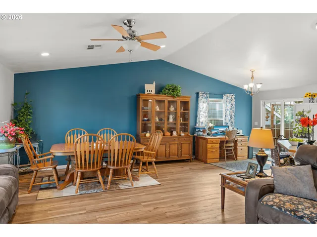 a living room with furniture a dining table with wooden floor