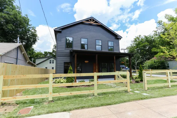 a view of house with a yard