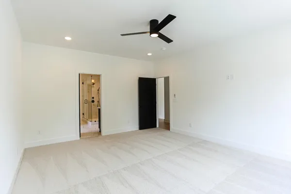 a view of empty room with ceiling fan