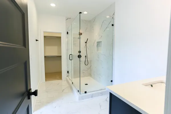 a bathroom with a shower and a sink