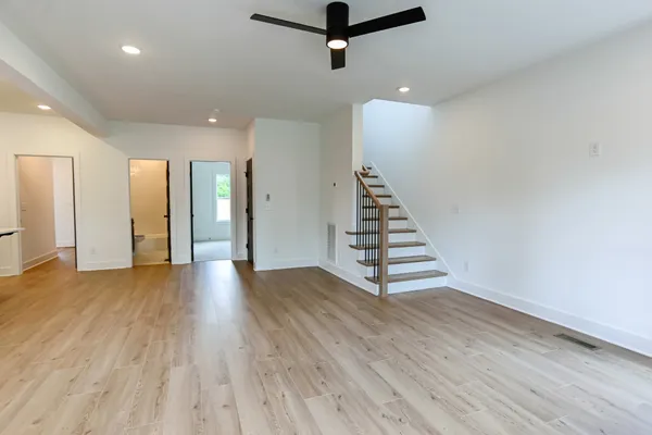 a view of a room with wooden floor and white walls