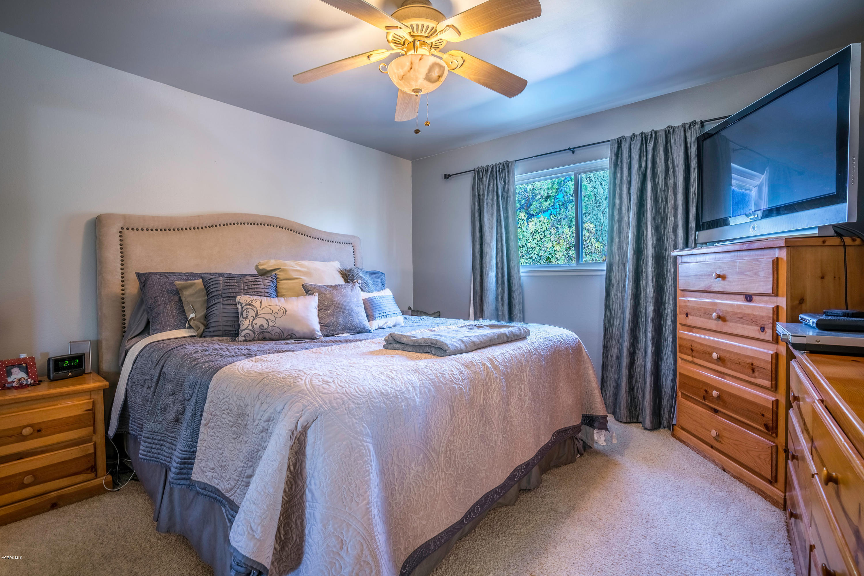 2849 Fitzgerald Road Simi Valley, CA 93065 - Photo 14 of 25 a bedroom with a bed and a chandelier