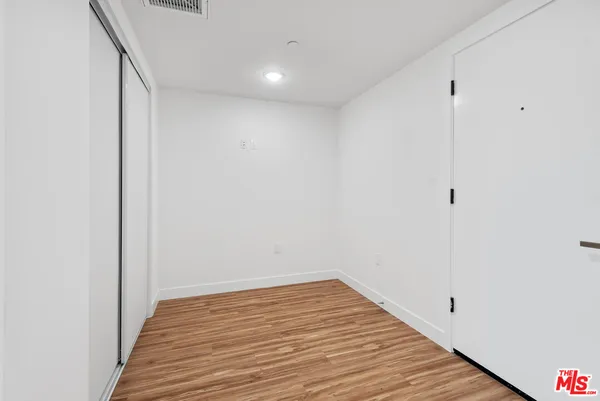 a view of a room with wooden floor